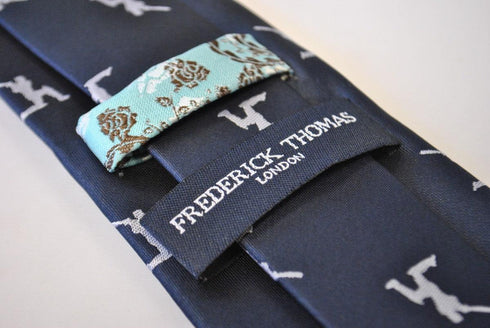 navy tie with white cricket player silhouette design